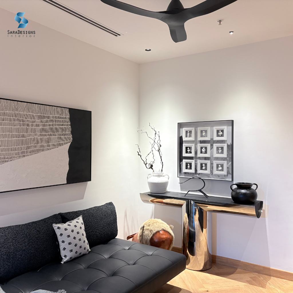 Black sofa with table with some artifacts in Entertainment Room at Trump Tower, Gurgaon